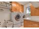 Functional laundry room featuring modern washer and dryer units, ample storage at 10315 Washam Potts Rd, Cornelius, NC 28031