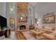 Inviting living room featuring a stone fireplace, hardwood floors, and abundant natural light at 10315 Washam Potts Rd, Cornelius, NC 28031