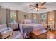 Comfortable main bedroom featuring hardwood floors, neutral tones, and plenty of natural light at 10315 Washam Potts Rd, Cornelius, NC 28031