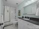 Charming bathroom with black and white tile floor, black countertop, and subway tile in shower at 106 N Turner Ave, Charlotte, NC 28216