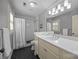 Bright bathroom features subway tile in shower and a white vanity with a large mirror at 106 N Turner Ave, Charlotte, NC 28216