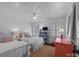 Bright bedroom features two twin beds, natural light through shuttered windows, and a ceiling fan at 106 N Turner Ave, Charlotte, NC 28216