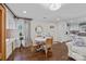 Cozy dining area features a white table, wicker chairs, and a view of the updated kitchen at 106 N Turner Ave, Charlotte, NC 28216