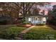 Charming bungalow with a welcoming front porch, brick path, and landscaped front yard at 106 N Turner Ave, Charlotte, NC 28216