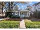 Charming bungalow with a welcoming front porch, brick path, and landscaped front yard at 106 N Turner Ave, Charlotte, NC 28216