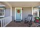 Inviting front porch with rocking chair and autumn wreath on the door at 106 N Turner Ave, Charlotte, NC 28216