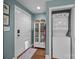 Hallway with a laundry closet and a door leading outside, featuring modern decor at 106 N Turner Ave, Charlotte, NC 28216