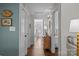 Hallway with hardwood floors leading to a bedroom and living space, enhanced by elegant wall decor at 106 N Turner Ave, Charlotte, NC 28216