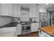 Bright kitchen with stainless steel appliances, white cabinets, subway tile backsplash, and gas range at 106 N Turner Ave, Charlotte, NC 28216