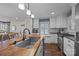 Charming kitchen featuring a butcher block island, stainless appliances, and a window seat with natural light at 106 N Turner Ave, Charlotte, NC 28216