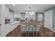 Updated kitchen features white cabinets, butcher block island, stainless steel appliances, and a cozy breakfast nook at 106 N Turner Ave, Charlotte, NC 28216