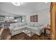 Inviting living room with hardwood floors, large sectional sofa, and a modern coffee table at 106 N Turner Ave, Charlotte, NC 28216