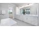 Bright primary bathroom featuring double vanity and modern soaking tub at 111 Monbo Meadows Ln, Statesville, NC 28677