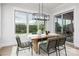 Bright dining room with large windows, modern light fixtures, and elegant table setting overlooking the landscape at 111 Monbo Meadows Ln, Statesville, NC 28677