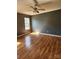 A well-lit bedroom with hardwood floors, a window, and a ceiling fan, providing a serene living space at 1110 Hollyberry Ln, Salisbury, NC 28147