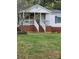 Charming home with a welcoming front porch, brick accents, well-manicured lawn, and cozy curb appeal at 1110 Hollyberry Ln, Salisbury, NC 28147