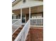 Charming front porch with stone accents, white railings, and brick stairs leading to a cozy entrance at 1110 Hollyberry Ln, Salisbury, NC 28147