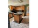 A spacious kitchen with tile floors, wood cabinets, black appliances, and center island, perfect for cooking at 1110 Hollyberry Ln, Salisbury, NC 28147
