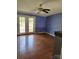 Living room with hardwood floors and glass patio doors offering natural light, creating an inviting atmosphere at 1110 Hollyberry Ln, Salisbury, NC 28147