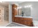 Bathroom featuring double vanity with wood cabinets, large mirror, linen tower, and glass enclosed shower at 1176 Fawn Ridge Nw Rd, Concord, NC 28027