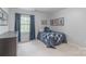 Inviting bedroom with blue accents, soft carpet, dresser, and a large window with natural light at 1176 Fawn Ridge Nw Rd, Concord, NC 28027