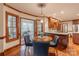 Well lit dining area with a modern light fixture, wood trim, and kitchen and sunroom access at 1176 Fawn Ridge Nw Rd, Concord, NC 28027