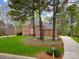 Charming two-story brick home with lush front lawn, mature trees, and a circular driveway offering serene curb appeal at 1176 Fawn Ridge Nw Rd, Concord, NC 28027