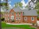 Handsome brick home showcasing manicured lawn, stately facade and white trimmed windows at 1176 Fawn Ridge Nw Rd, Concord, NC 28027
