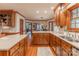 Open kitchen featuring wood cabinetry, granite countertops, and views of the breakfast area at 1176 Fawn Ridge Nw Rd, Concord, NC 28027