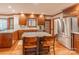 Traditional kitchen features wood cabinets, stainless steel appliances, and center island with seating at 1176 Fawn Ridge Nw Rd, Concord, NC 28027