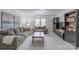 Living room with two sofas, soft carpet, built-in shelves, and a neutral color palette at 1176 Fawn Ridge Nw Rd, Concord, NC 28027