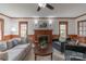 Cozy living room with wood trim, a fireplace, and comfortable seating, creating a warm atmosphere at 1176 Fawn Ridge Nw Rd, Concord, NC 28027