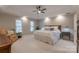 Main bedroom with ceiling fan, sitting area, and neutral decor at 1176 Fawn Ridge Nw Rd, Concord, NC 28027