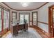 Bright home office featuring hardwood floors, windows, and wood trim and desk at 1176 Fawn Ridge Nw Rd, Concord, NC 28027