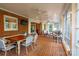 Light-filled sunroom featuring brick flooring, ample seating, and a cozy dining area at 1176 Fawn Ridge Nw Rd, Concord, NC 28027
