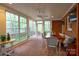 Bright sunroom with large windows, ceiling fan, brick floor, dining table and outdoor views at 1176 Fawn Ridge Nw Rd, Concord, NC 28027