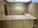 Basement featuring wood paneled walls and built in bar with countertop at 1199 Riding Trail Ln, Concord, NC 28027
