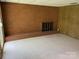 Spacious basement featuring brick fireplace and paneled walls at 1199 Riding Trail Ln, Concord, NC 28027