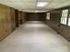Spacious basement featuring paneled walls, tiled flooring and large windows at 1199 Riding Trail Ln, Concord, NC 28027