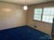 A cozy bedroom featuring blue carpet, and two sunlit windows at 1199 Riding Trail Ln, Concord, NC 28027