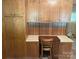 Wood paneled office area with matching cabinets and desk at 1199 Riding Trail Ln, Concord, NC 28027