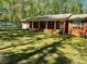 Charming brick ranch with a covered front porch and a detached garage at 1199 Riding Trail Ln, Concord, NC 28027