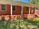Charming brick ranch with a covered front porch and brick steps at 1199 Riding Trail Ln, Concord, NC 28027