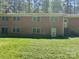Brick home with large backyard, several windows, and an exterior staircase at 1199 Riding Trail Ln, Concord, NC 28027