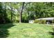 Expansive backyard with a storage shed and mature trees, offering plenty of space at 1201 Robinhood Cir, Charlotte, NC 28227