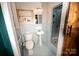 Light blue bathroom with walk-in shower and wood sliding door at 1201 Robinhood Cir, Charlotte, NC 28227