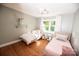 Bright bedroom with two twin beds, hardwood floors, and a ceiling fan at 1201 Robinhood Cir, Charlotte, NC 28227