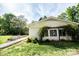 A sunny view of the exterior shows nice landscaping and a brick walkway at 1201 Robinhood Cir, Charlotte, NC 28227