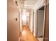 Hallway with hardwood floors and several doors leading to other rooms at 1201 Robinhood Cir, Charlotte, NC 28227