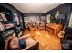 Bright living room with hardwood floors, bookcases, and cozy armchairs at 1201 Robinhood Cir, Charlotte, NC 28227
